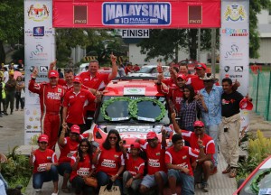 Gauvrav Gill seen with his wife Dr Shilpa (checks shirt on the right side) as he poses with MRF Skoda Team after winning the APRC Malaysian leg. An Adrenna image