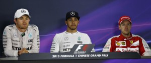 Mercedes AMG Petronas driver Lewis Hamilton (centre) and teammate Nico Rosberg (left) comment on each others' race on Sunday. An FIA image