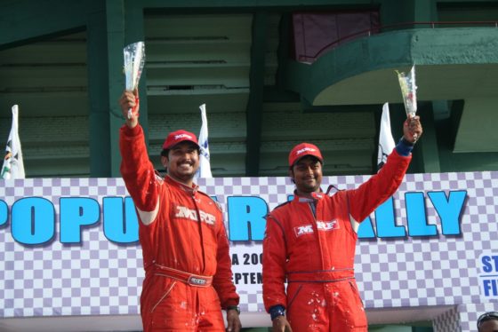 Lohith Urs and co-driver Chandramouli pose with trophies at the podium ceremony after winning the Popular Rally on Sunday.  Photo by George Francis